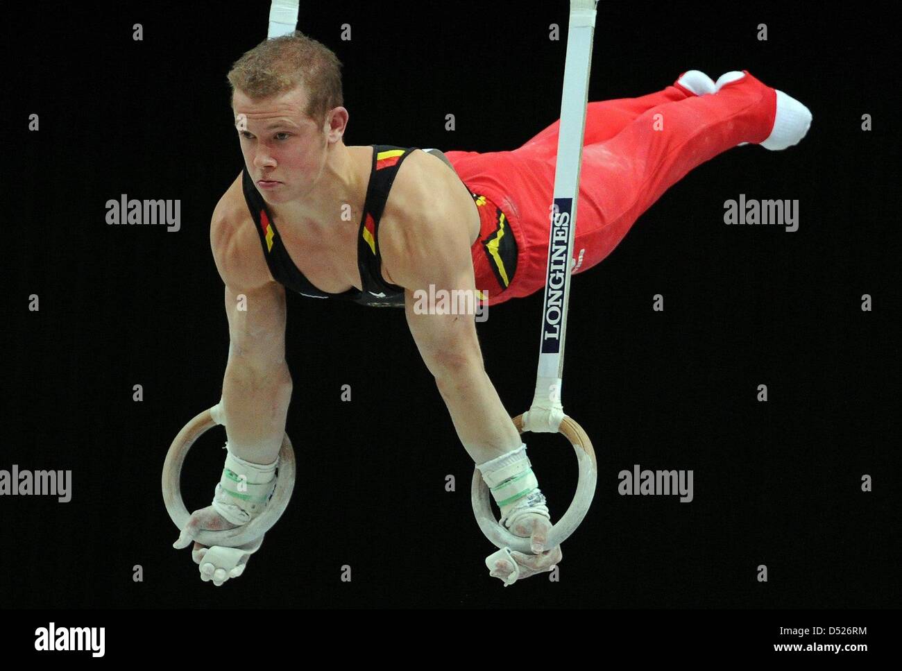 German gymnast Fabian Hambuechen performs his skills on the rings during the team final of the