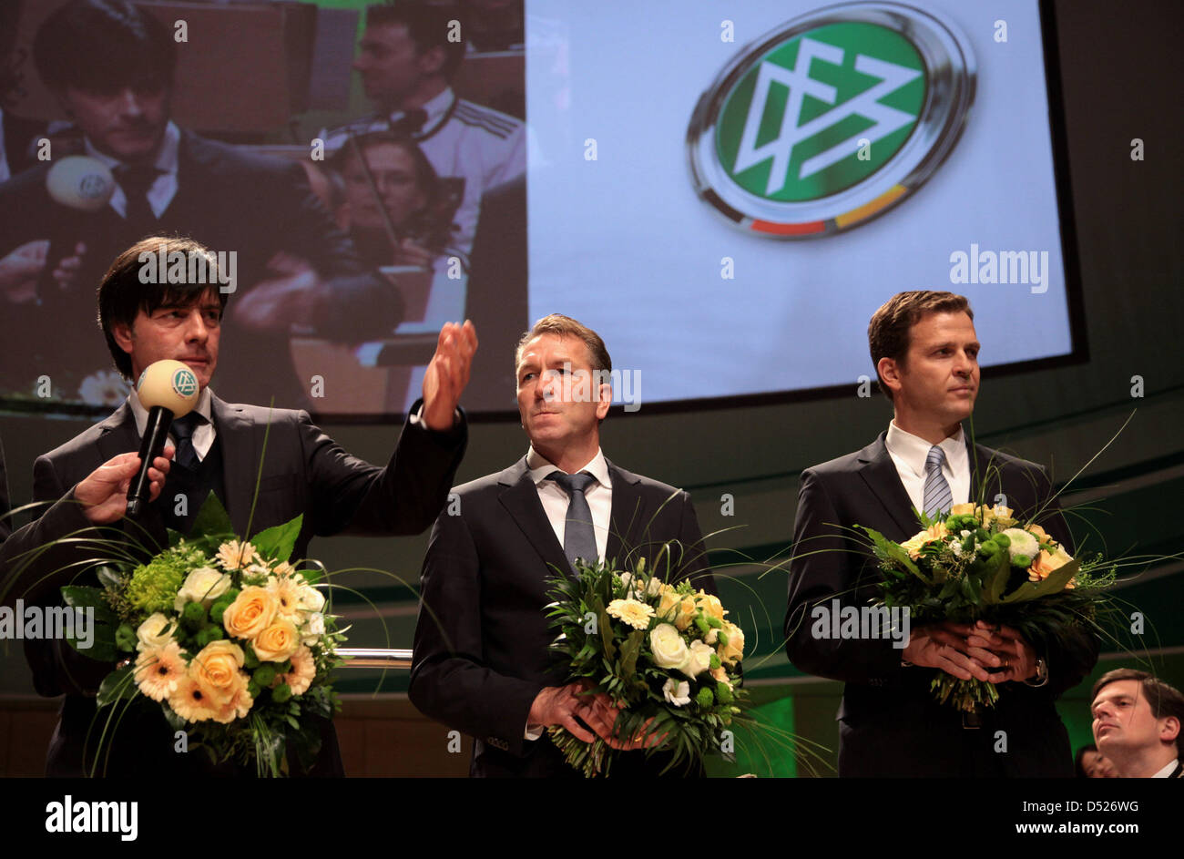 Head coach Joachim Loew (L-R), goalkeeper coach Andreas Koepcke and Manager Oliver Bierhoff of the German national football team are honored by Theo Zwanziger, president of the German Football Association (DFB) during the DFB Bundestag at the Philharmonie on October 21, 2010 in Essen, Germany. Photo: by Friedemann Vogel/Bongarts/Getty Images Stock Photo