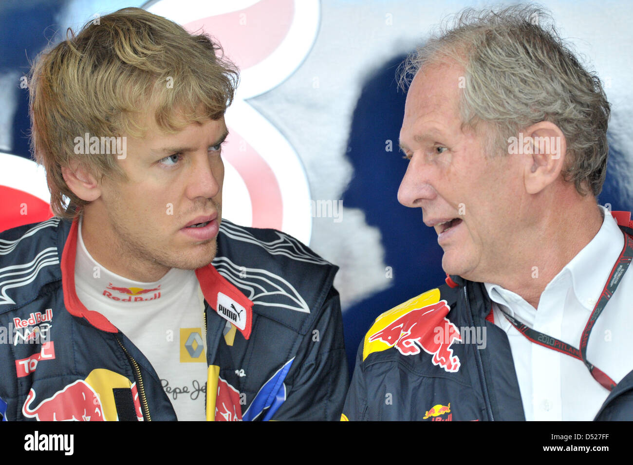 German driver Sebastian Vettel (L) of Red Bull and Helmut Marko, motorsports director of Red Bull, talk to each other during a training session at the Korea Internation Circuit in Yeongam, South Korea, 23 October 2010. The maiden Formula One Korean Grand Prix is held on 24 October 2010. Photo: David Ebener Stock Photo