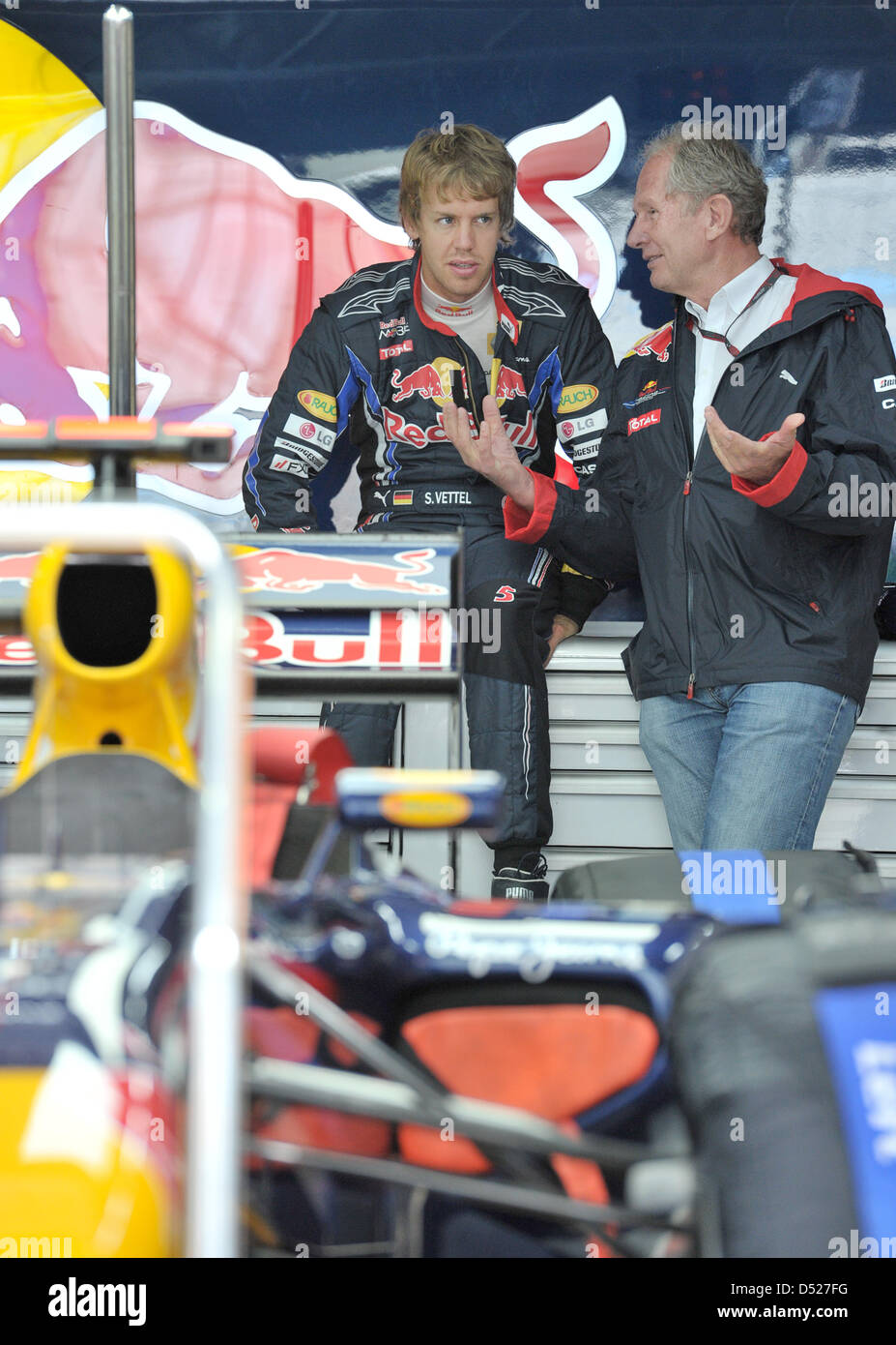 German driver Sebastian Vettel (L) of Red Bull and Helmut Marko, motorsports director of Red Bull, talk to each other during a training session at the Korea Internation Circuit in Yeongam, South Korea, 23 October 2010. The maiden Formula One Korean Grand Prix is held on 24 October 2010. Photo: David Ebener Stock Photo