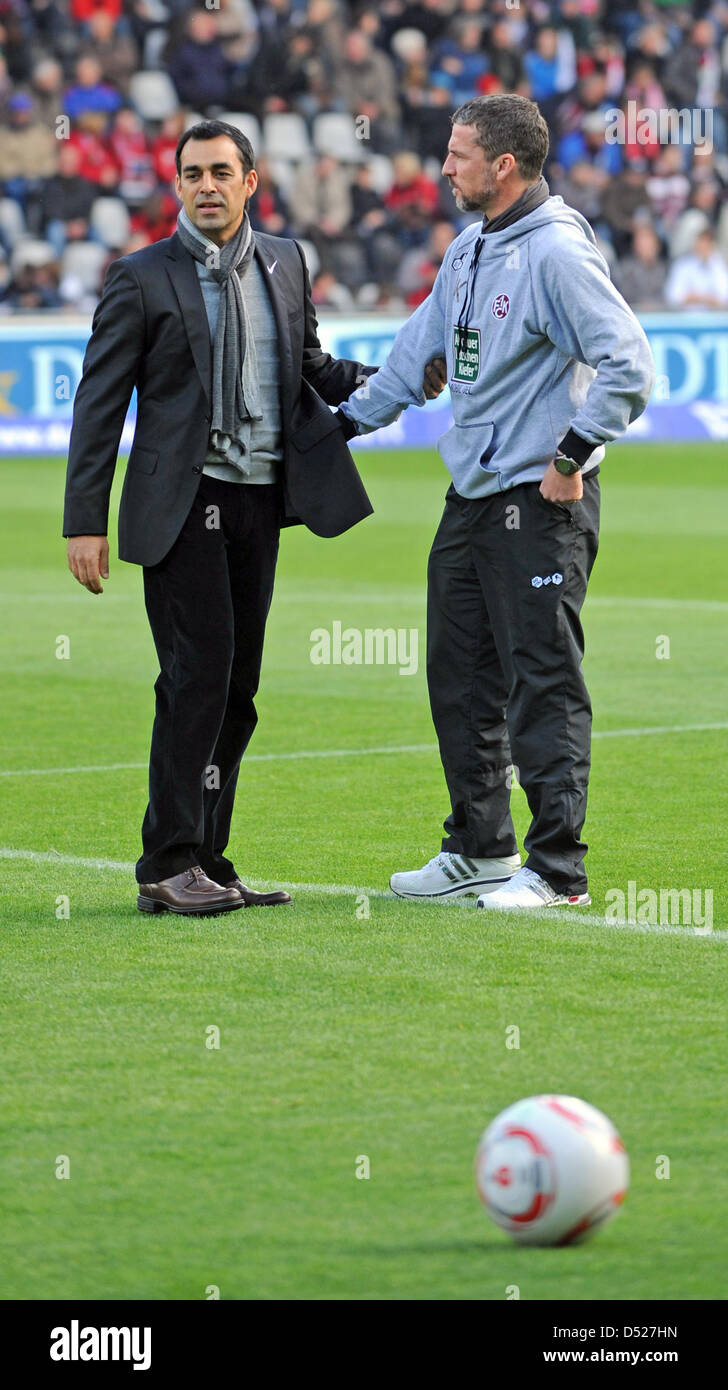Freiburg's head coach Robin Dutt (L) talks to Kaiserslautern's head coach Marco Kurz before the start of German Bundesliga match SC Freiburg vs. FC Kaiserslautern in the Badenova stadium in Freiburg, Germany, 23 October 2010. Photo: Patrick Seeger (ATTENTION: EMBARGO CONDITIONS! The DFL permits the further utilisation of the pictures in IPTV, mobile services and other new technolog Stock Photo