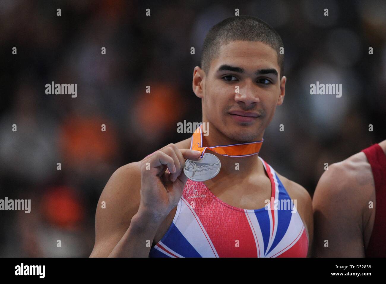 Louis Smith from Great Britain (silver)holds his medal during the medal