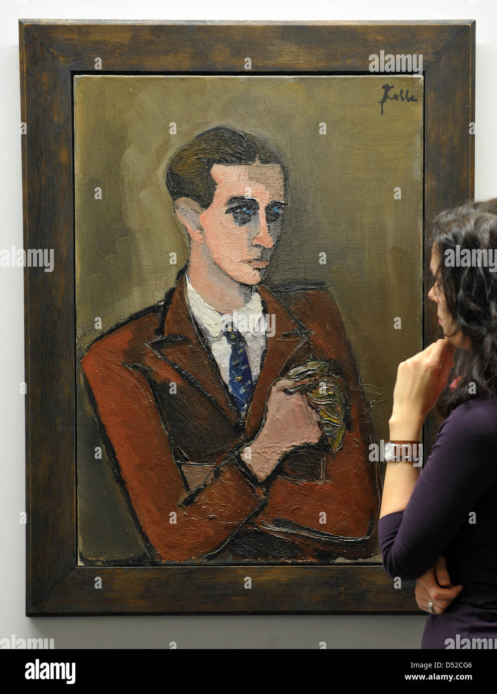 A young woman observes the painting 'Self-portrait with handkerchief' of Helmut Kolle of the art collection Chemnitz at the Museum Gunzenhauser in Chemnitz, Germany, 04 November 2010. The exhibition with the title 'Helmut Kolle. A German in Paris' is opened on 06 November 2010 and presents 90 artworks of the remarkable artist. Photo: Hendrik Schmidt Stock Photo