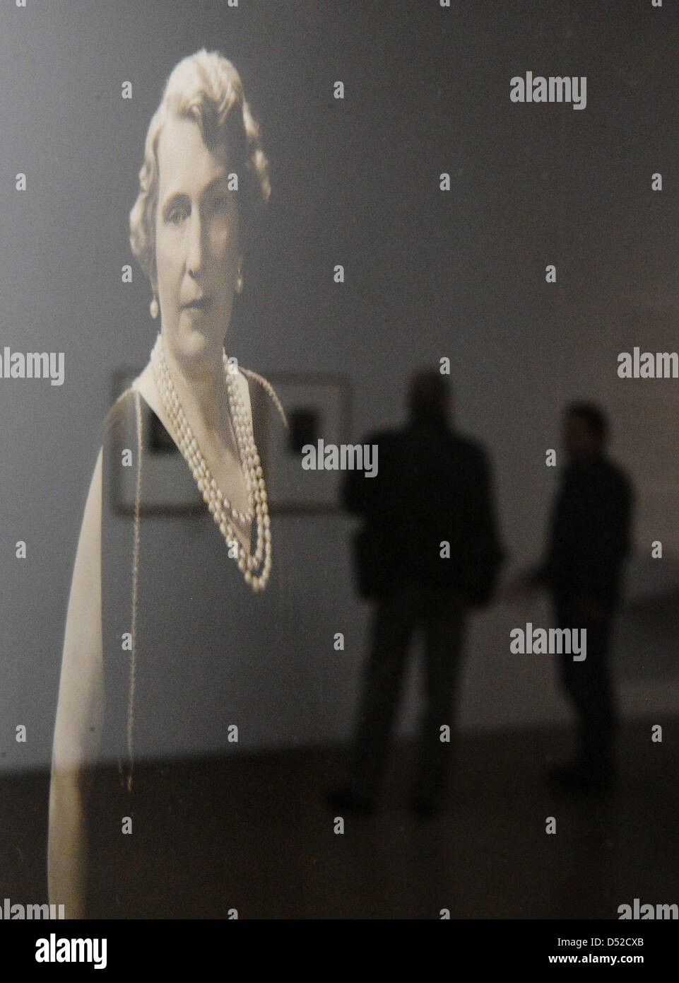Visitors mirror in the photography 'Queen Victoria Eugenia of Spain' by US photographer Edward Steichen on display in the exhibition 'Celebrity Design' at Folkwang Museum in Essen, Germany, 05 November 2010. Three new exhibitions are on display at Folkwang Museum from 06 November on. Photo: JULIAN STRATENSCHULTE Stock Photo