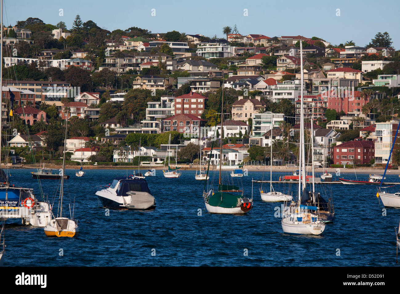 Waterfront apartment buildings and houses with moored pleasure boats at Rose Bay Eastern Suburbs Sydney Australia Stock Photo