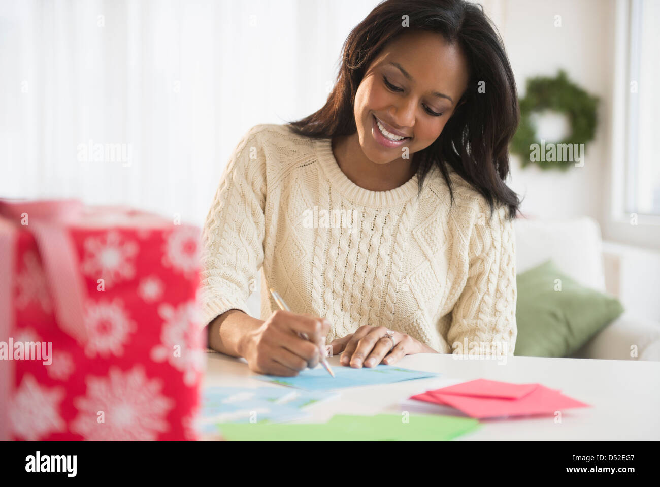 African American woman writing at desk Stock Photo