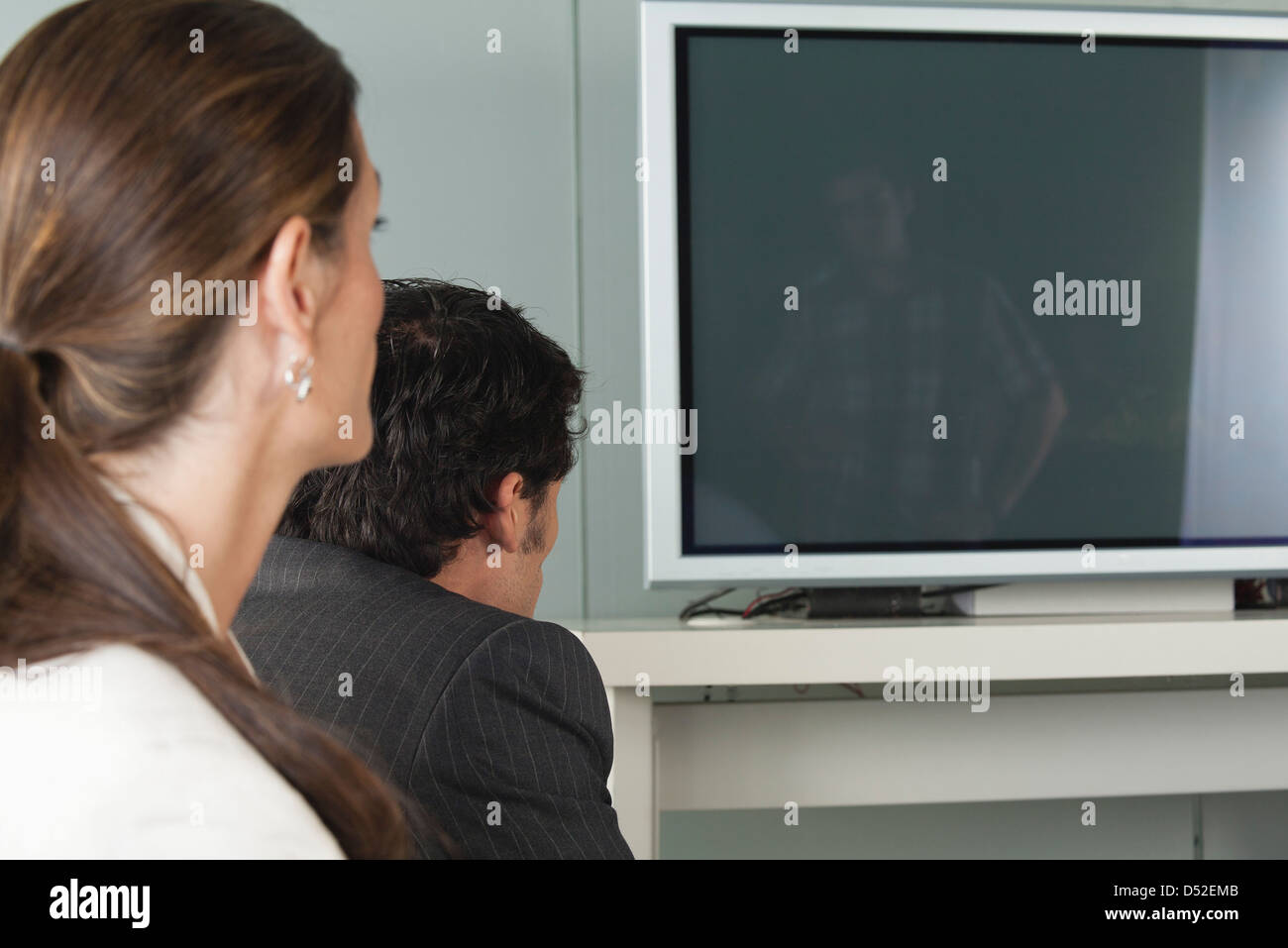 Colleagues watching television, side view Stock Photo - Alamy