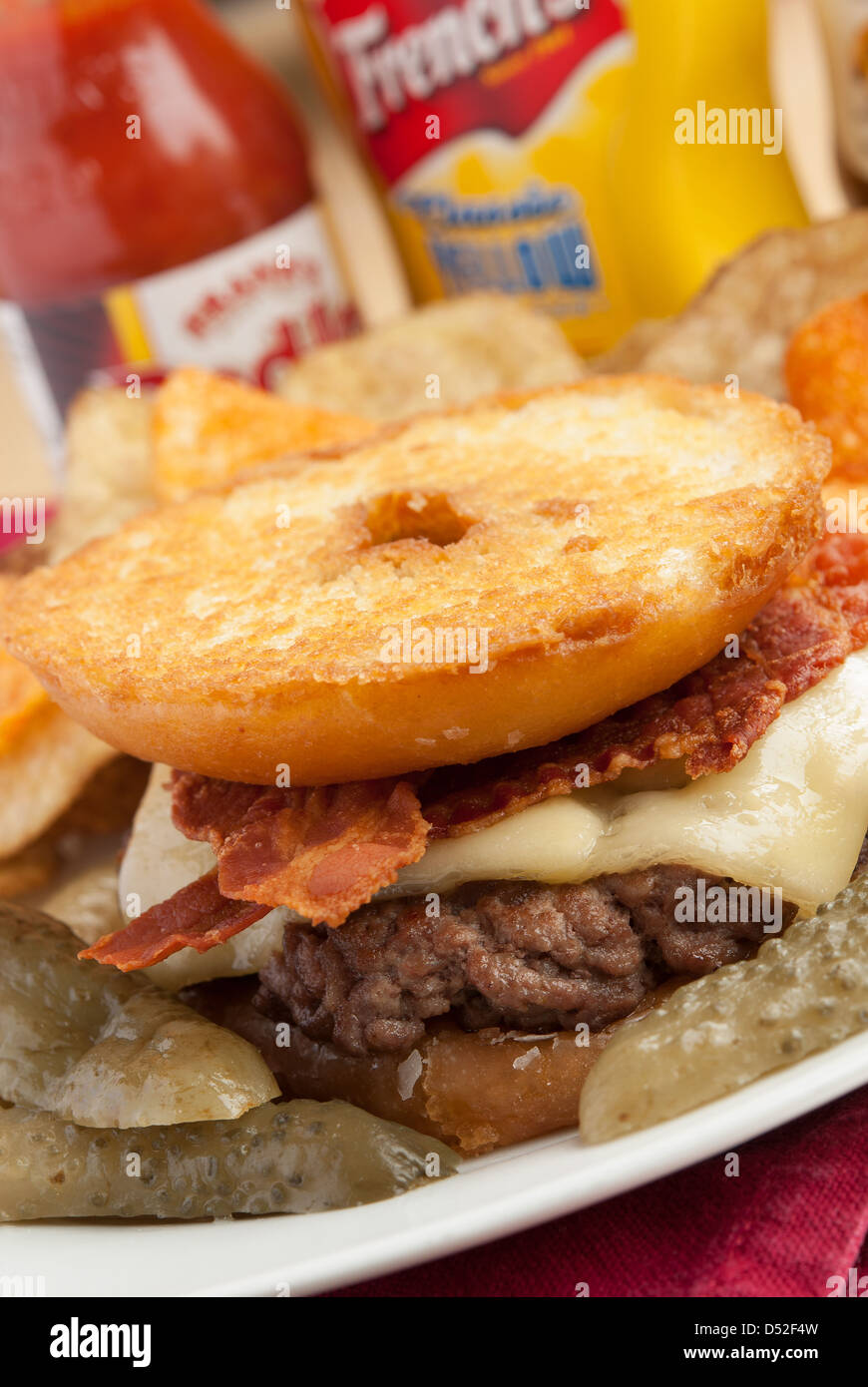 A burger, with a glazed ring doughnut instead of a bap (aka the Luther burger). Stock Photo