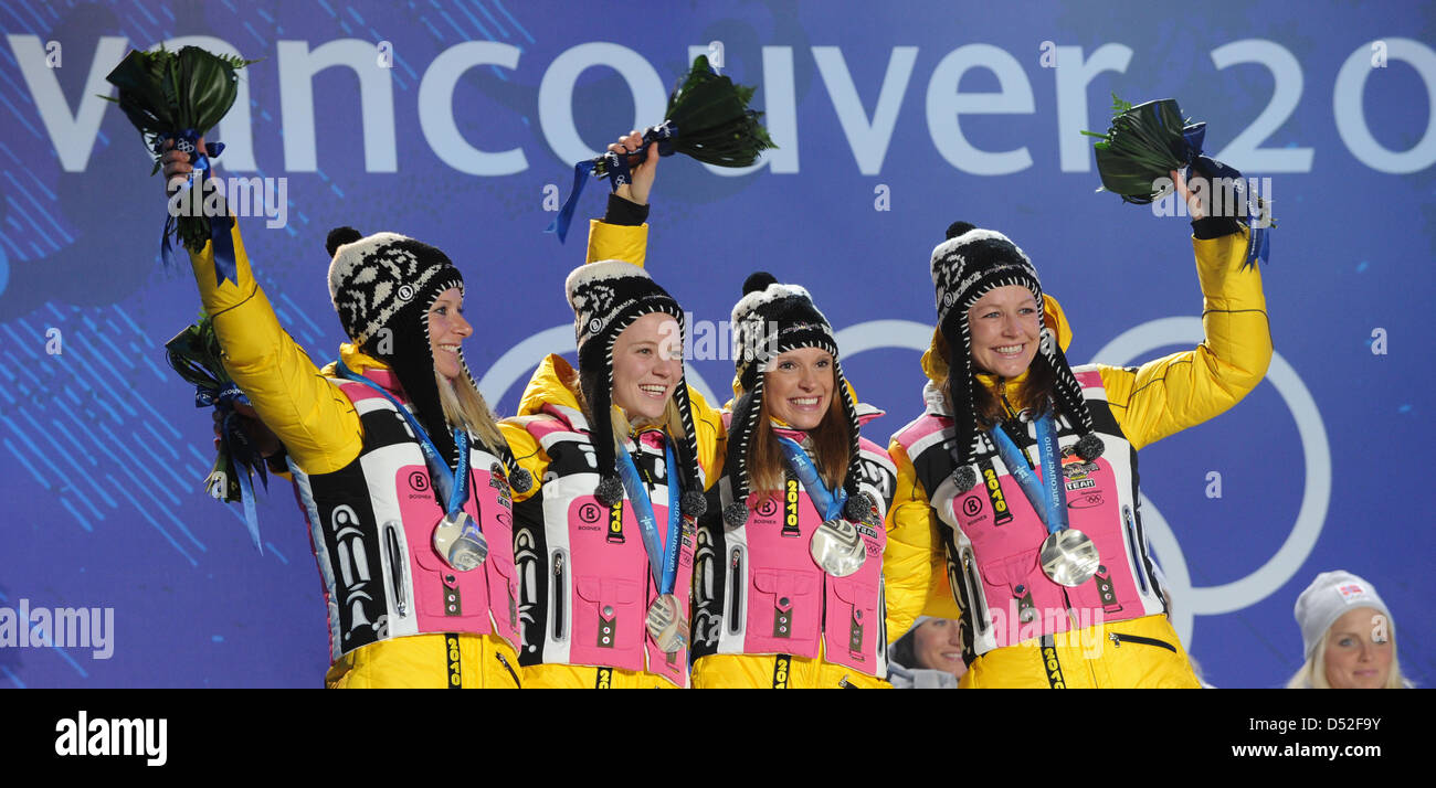 Silver medalists Katrin Zeller (R-L), Evi Sachenbacher-Stehle, Miriam Gossner and Claudia Nystad of Germany celebrate on the podium during the medal ceremony for the Women's 4x5 km Relay Classic/Free Cross Country Skiing at the Whistler Medal Plaza during the Vancouver 2010 Olympic Games in Whistler, Canada, 25 February 2010. Photo: Martin Schutt Stock Photo