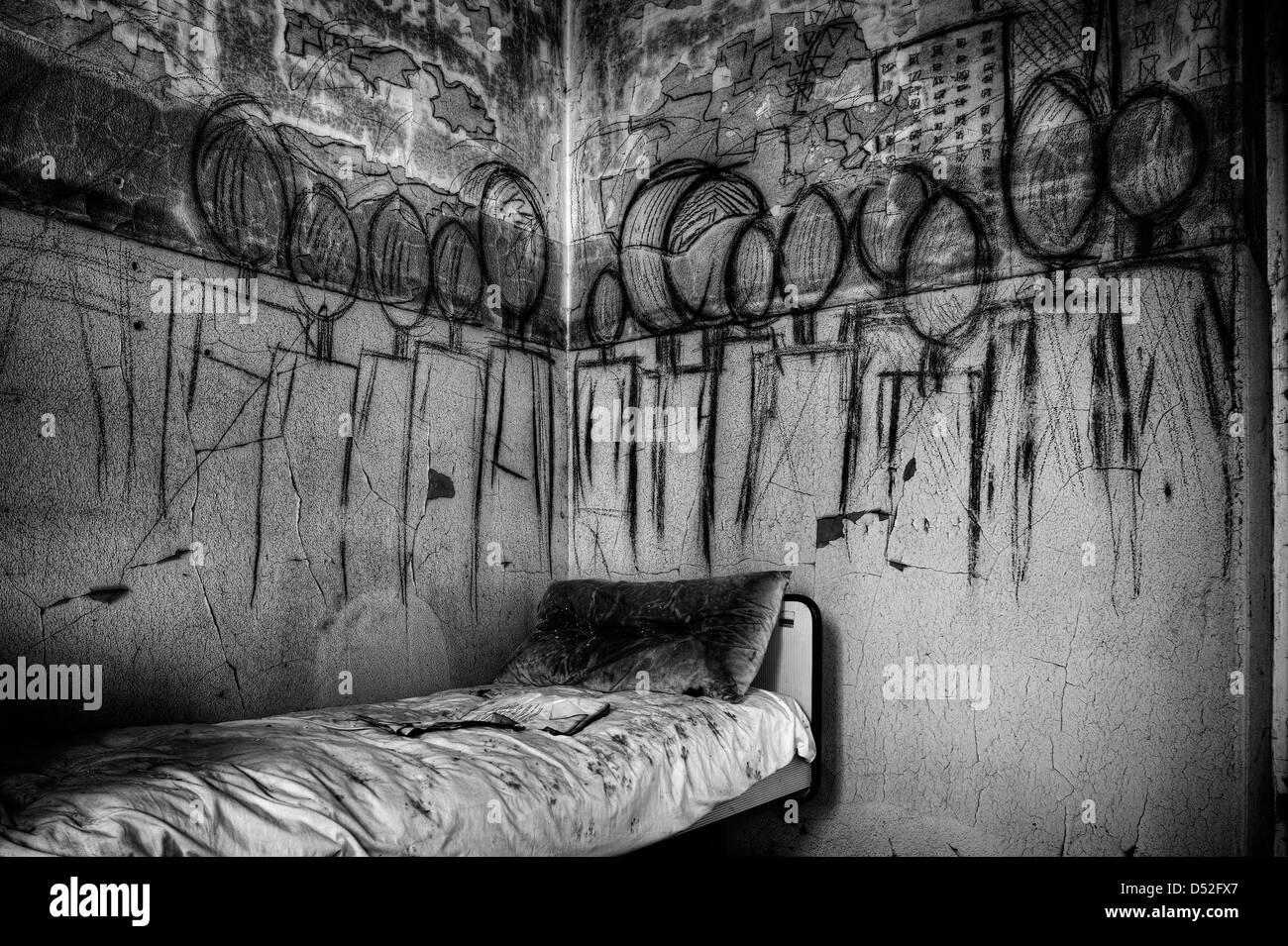 Italy. Abandoned psychiatric hospital. Mural with materialized nightmares Stock Photo