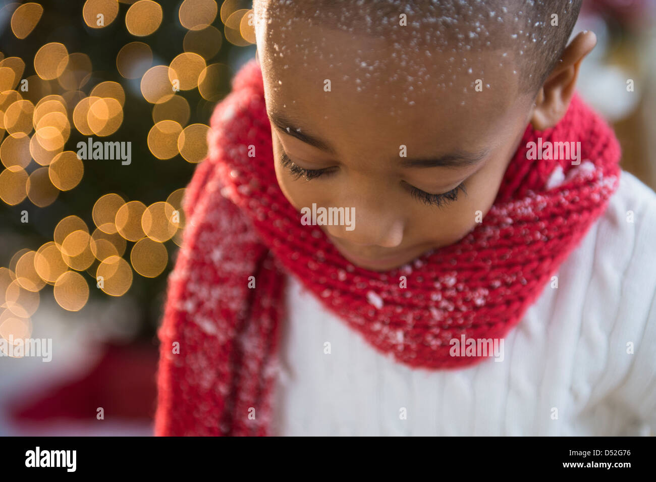 African American boy wearing scarf in snow Stock Photo