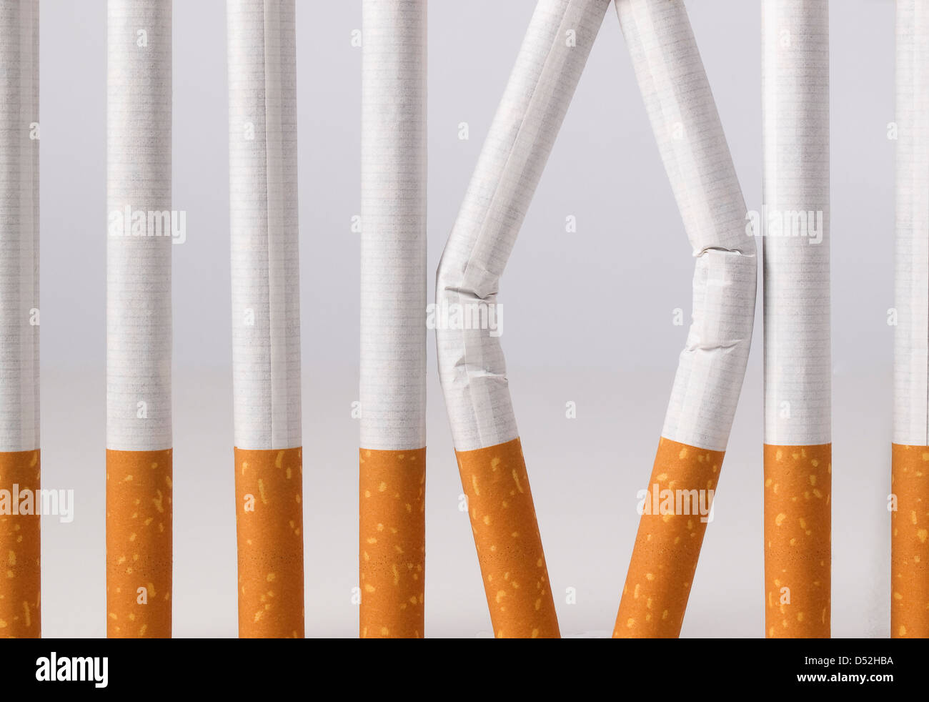 tobacco in prison Some cigarettes imitating a prison with bars. You can stop smoking Stock  Photo