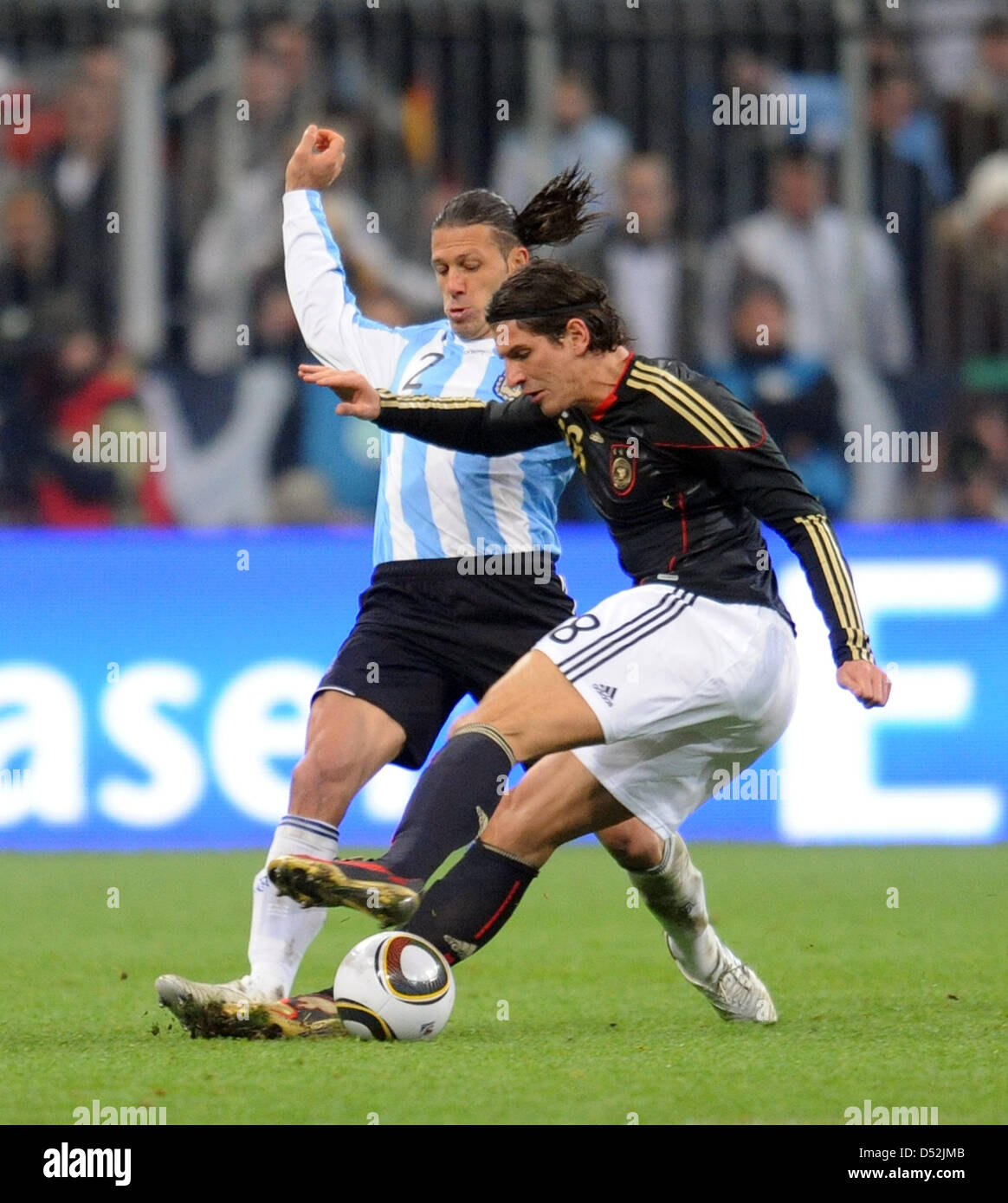 Germany's Mario Gomez (R) and Argentina's Martin Demichelis vie for the ball during the soccer friendly match Germany vs Argentina at AllianzArena stadium in Munich, Germany, 03 March 2010. Photo: Bernd Weissbrod Stock Photo