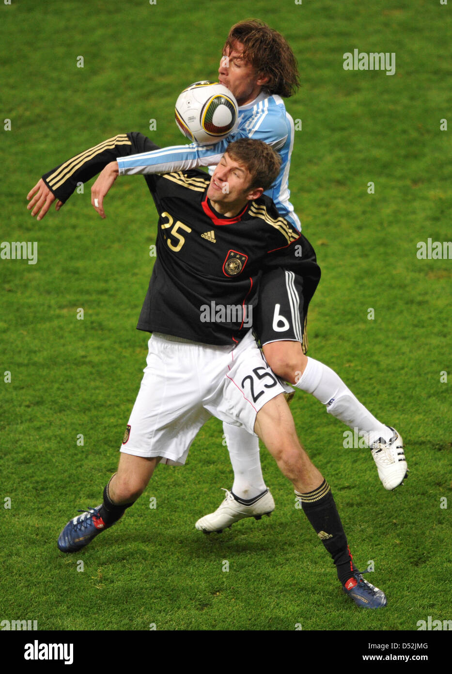 Germany's Thomas Mueller (front) and Argentina's Gabriel Heinze vie for the ball during the soccer friendly match Germany vs Argentina at AllianzArena stadium in Munich, Germany, 03 March 2010. Photo: Peter Kneffel Stock Photo