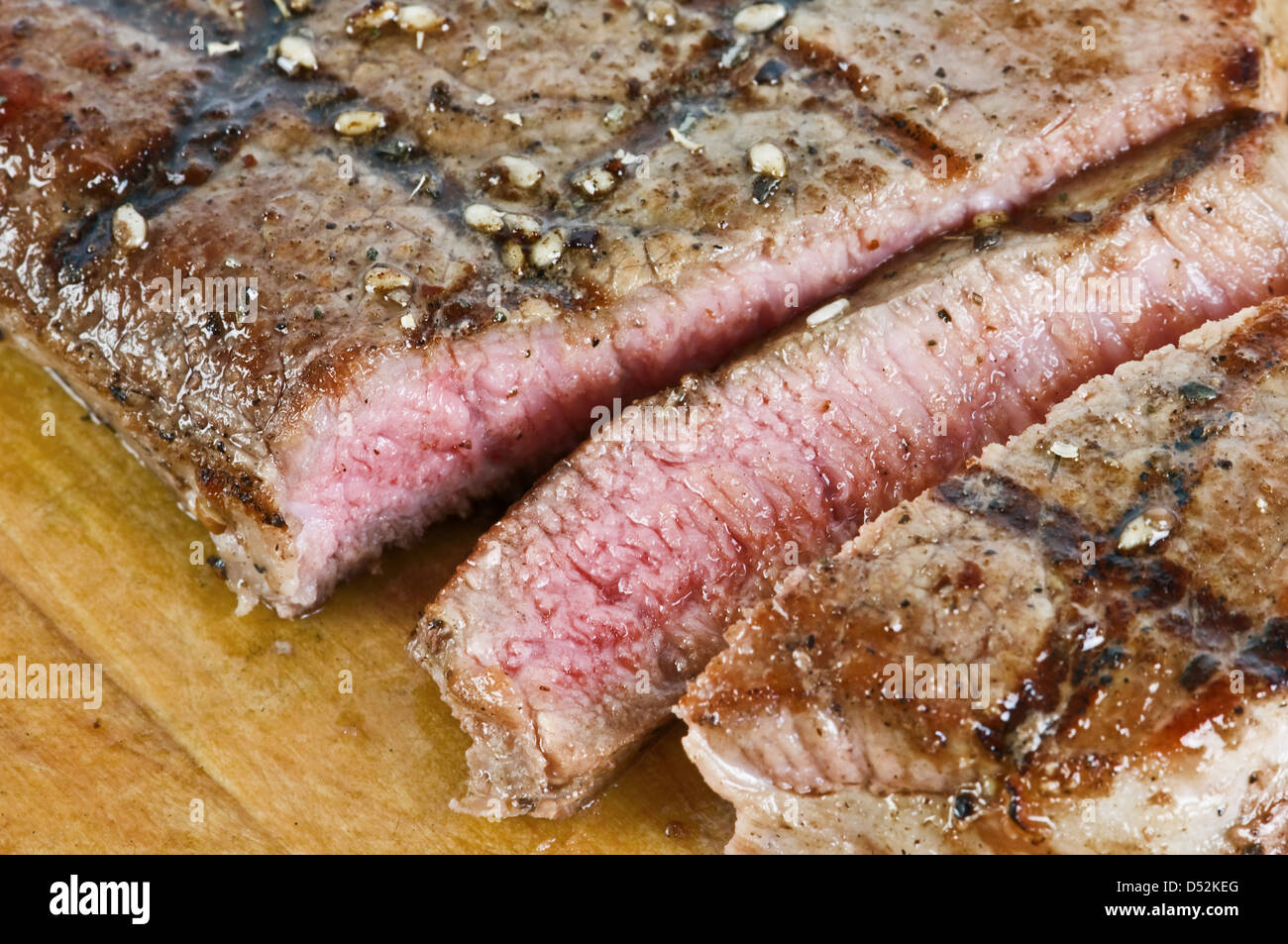 juicy striped steak on wood table Stock Photo