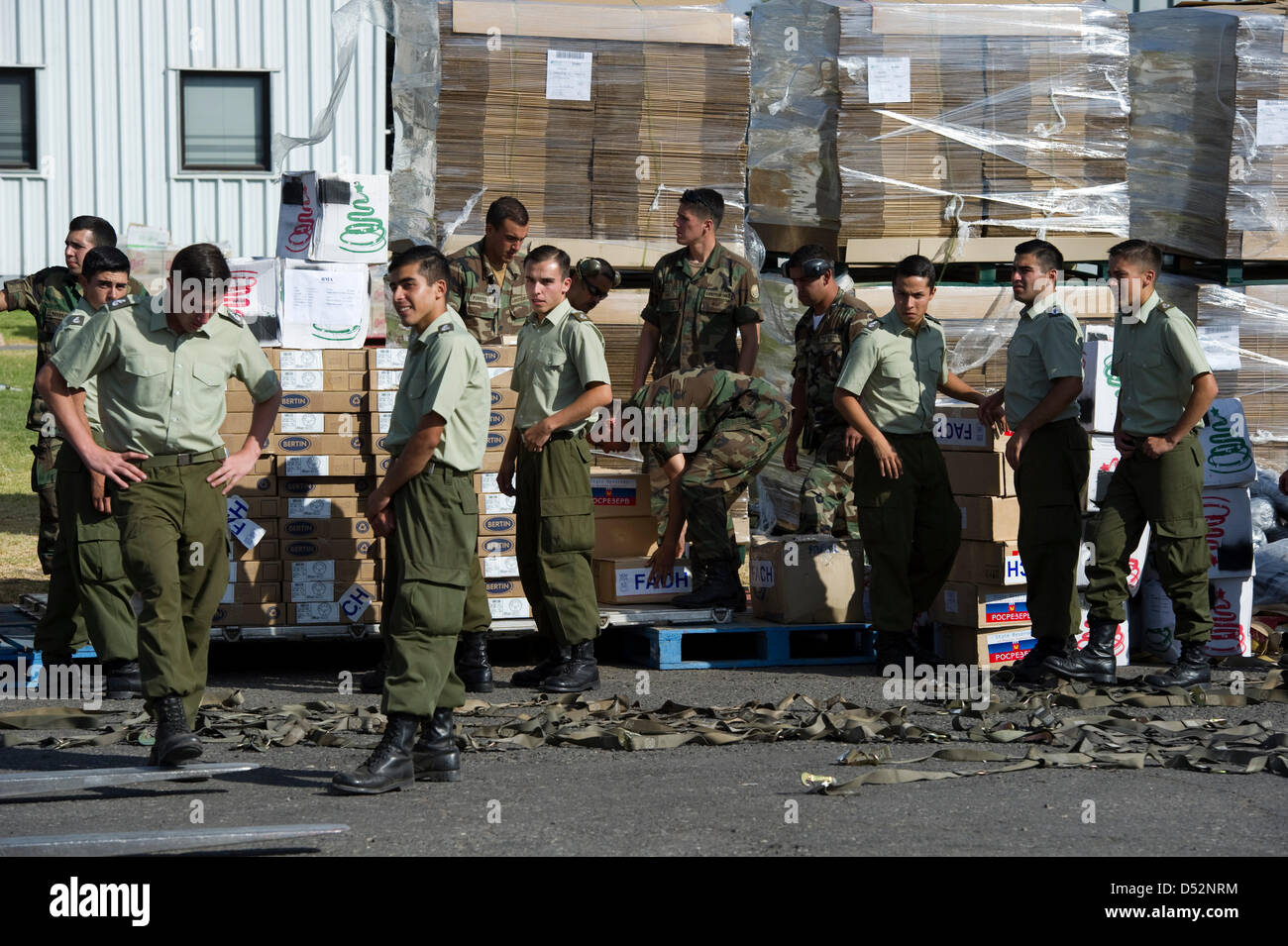 Soldiers stand amidst relief supplies for the earthquake victims at the airport in Santiago de Chile, Chile, 07 March 2010. Photo: Arno Burgi Stock Photo