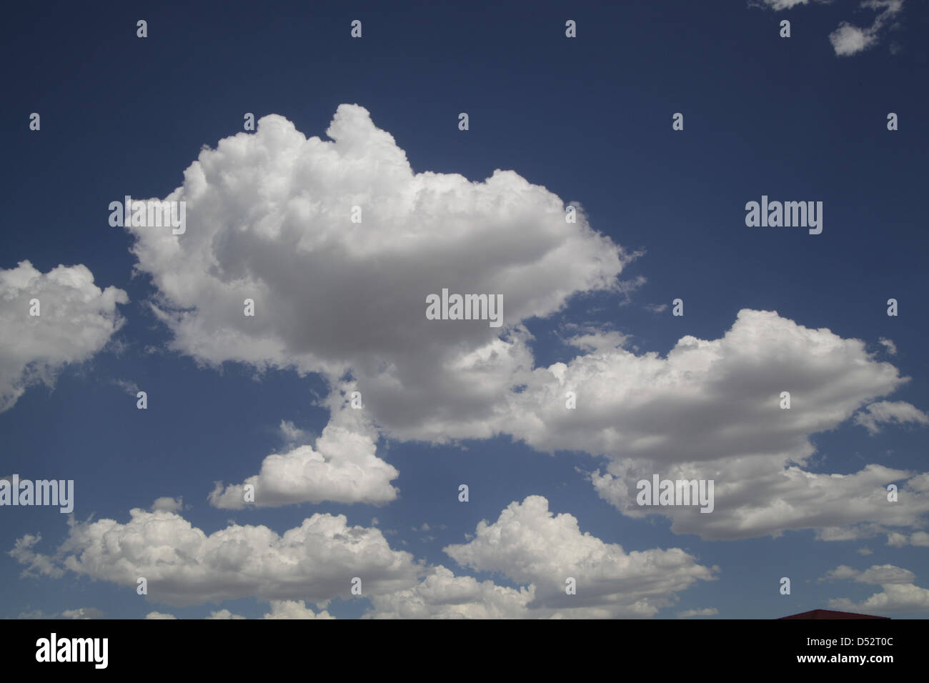 Blue sky and white puffy clouds Stock Photo - Alamy