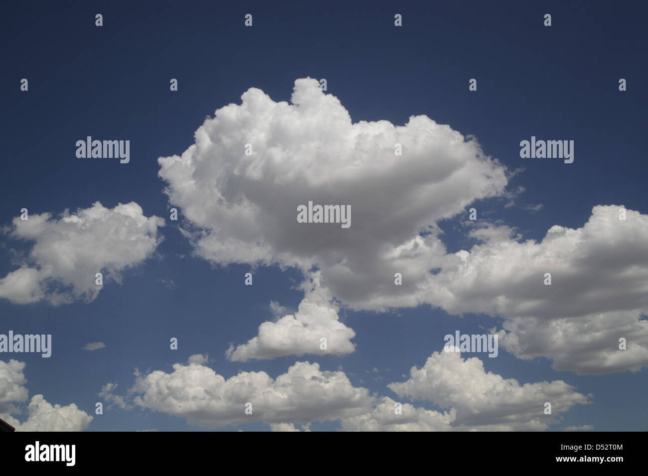 Blue sky and white puffy clouds Stock Photo - Alamy