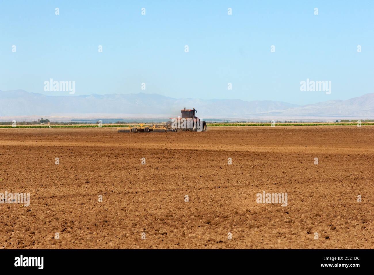 Discing and leveling a field after crops were harvested Stock Photo Alamy