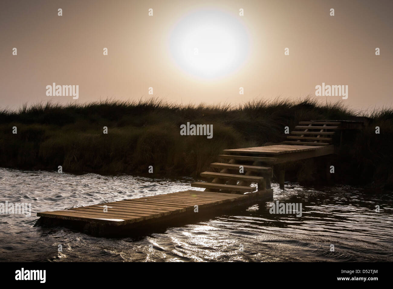 WOODEN JETTY, SUNSET, SAN JUAN DEL PUERTO, HUELVA, RIO TINTO MARSHLANDS, ESTUARY, SPAIN Stock Photo