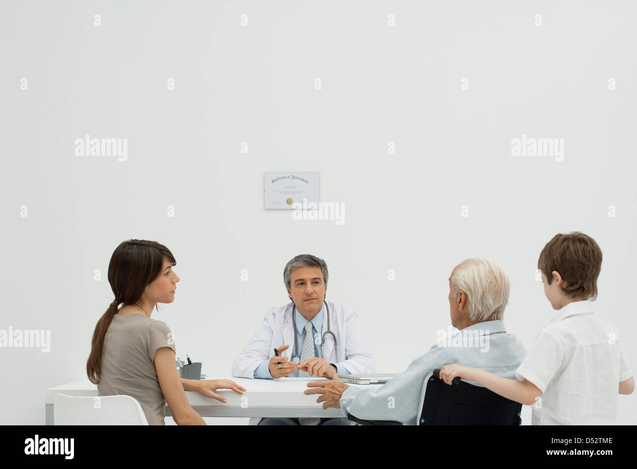 Doctor talking with senior patient and his family Stock Photo