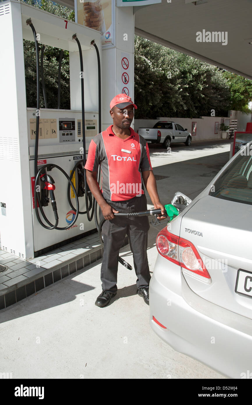 Petrol pump attendant filling car with fuel at a filling station in Knysna South Africa Stock