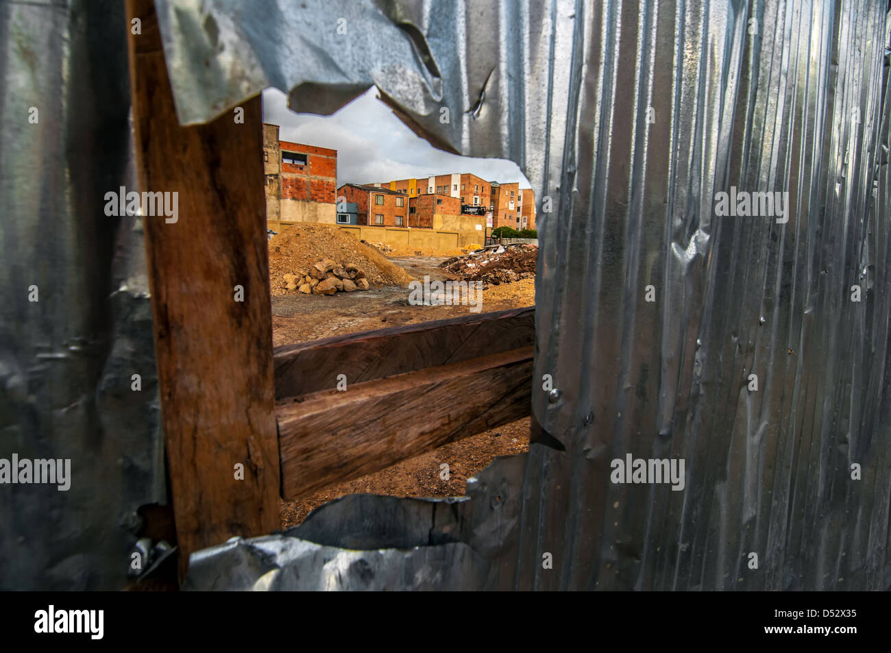 View of a construction site through a hole in a fence Stock Photo