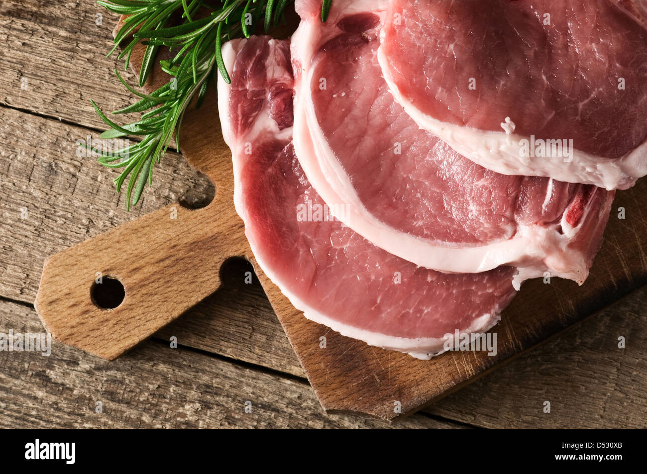pork pieces on wood table closeup Stock Photo