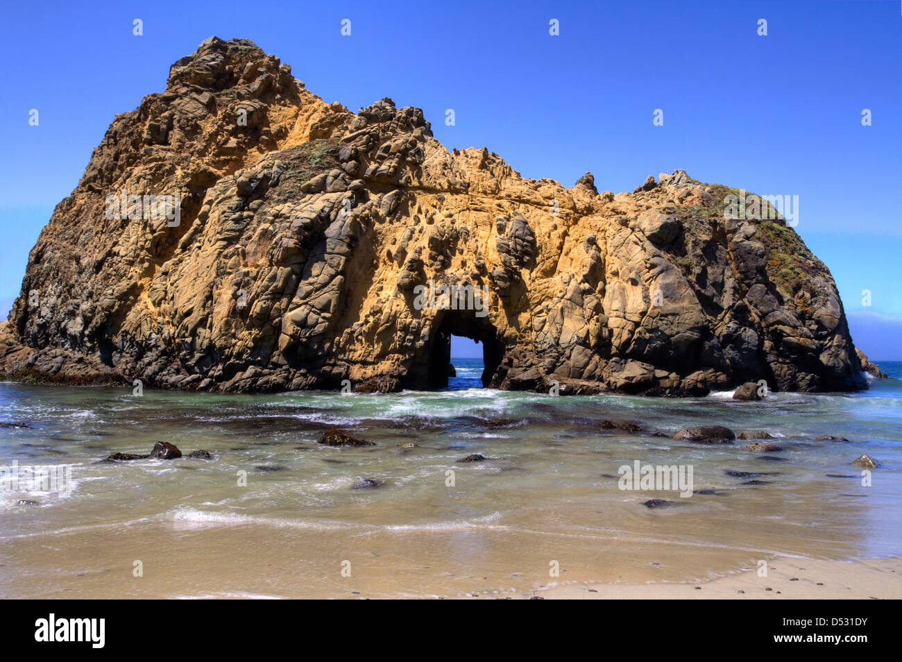 Offshore stack with an arch at Pfeiffer Beach in the Julia Pfeiffer Big Sur State Park, California, USA in January Stock Photo