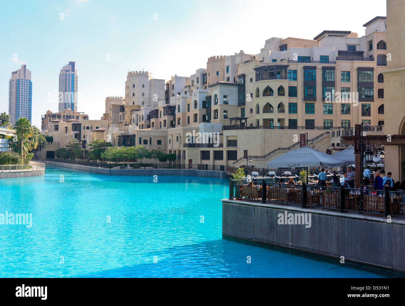 Souk al Bahar and the Skyline of Dubai Downtown, seen across the fountain lake, United Arab Emirates Stock Photo