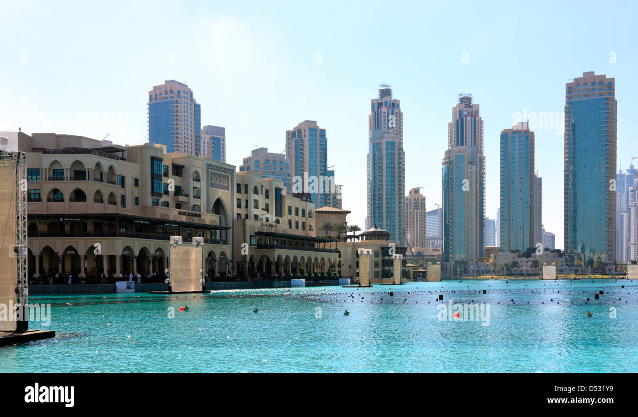 Souk al Bahar and the Skyline of Dubai Downtown, seen across the fountain lake, United Arab Emirates Stock Photo