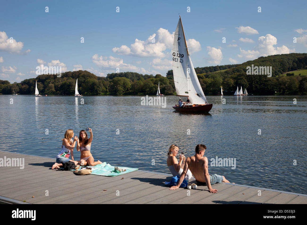 Essen, Germany, sailboats on the Baldeneysee and people at the boat dock Stock Photo