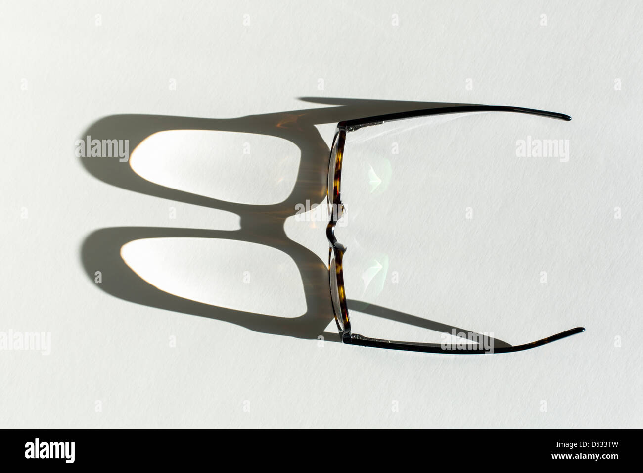 eye glasses casting shadow Stock Photo