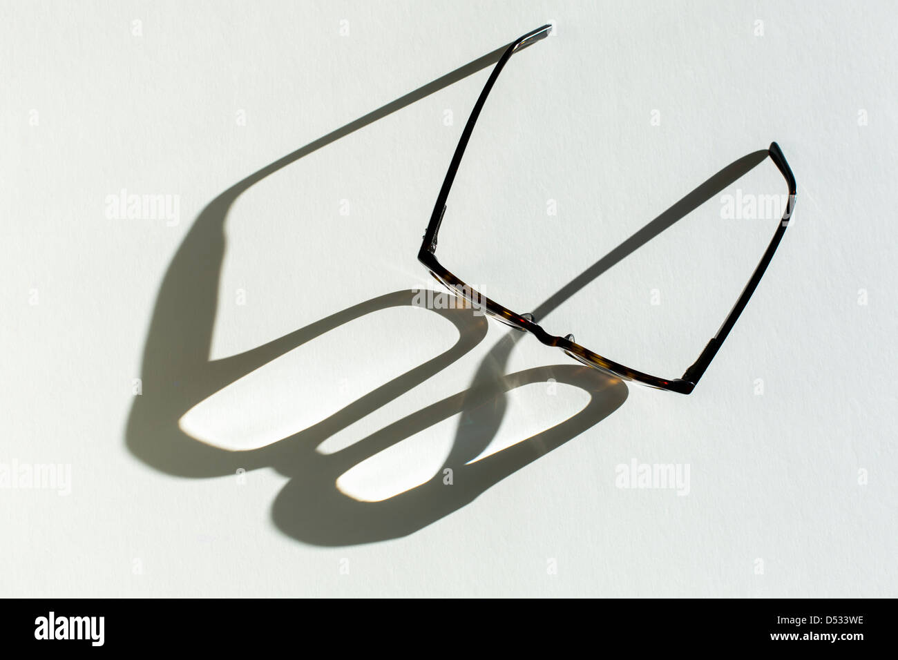eye glasses casting shadow Stock Photo