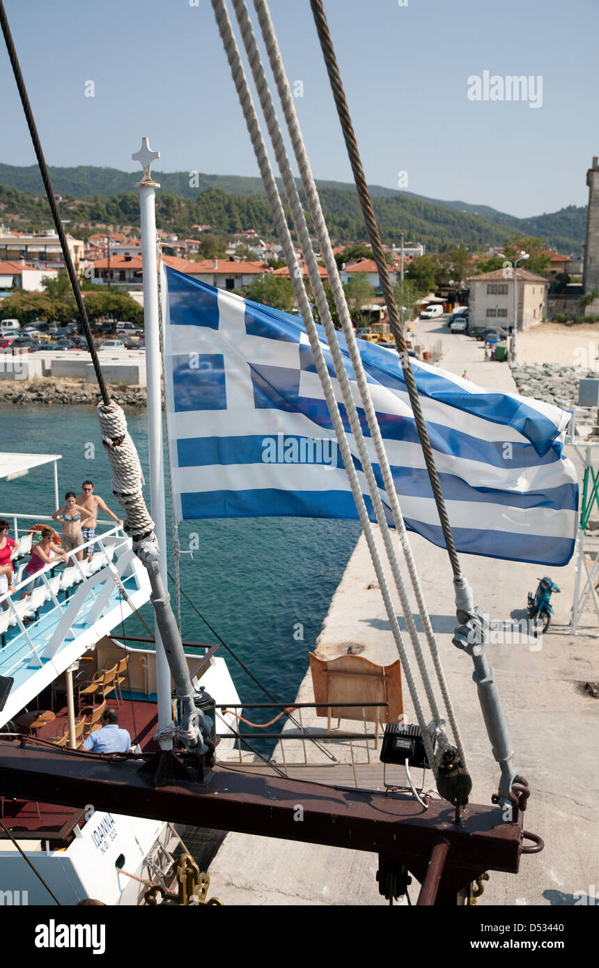 Sarti, Greece, with Greek flag cruise ship in port Stock Photo