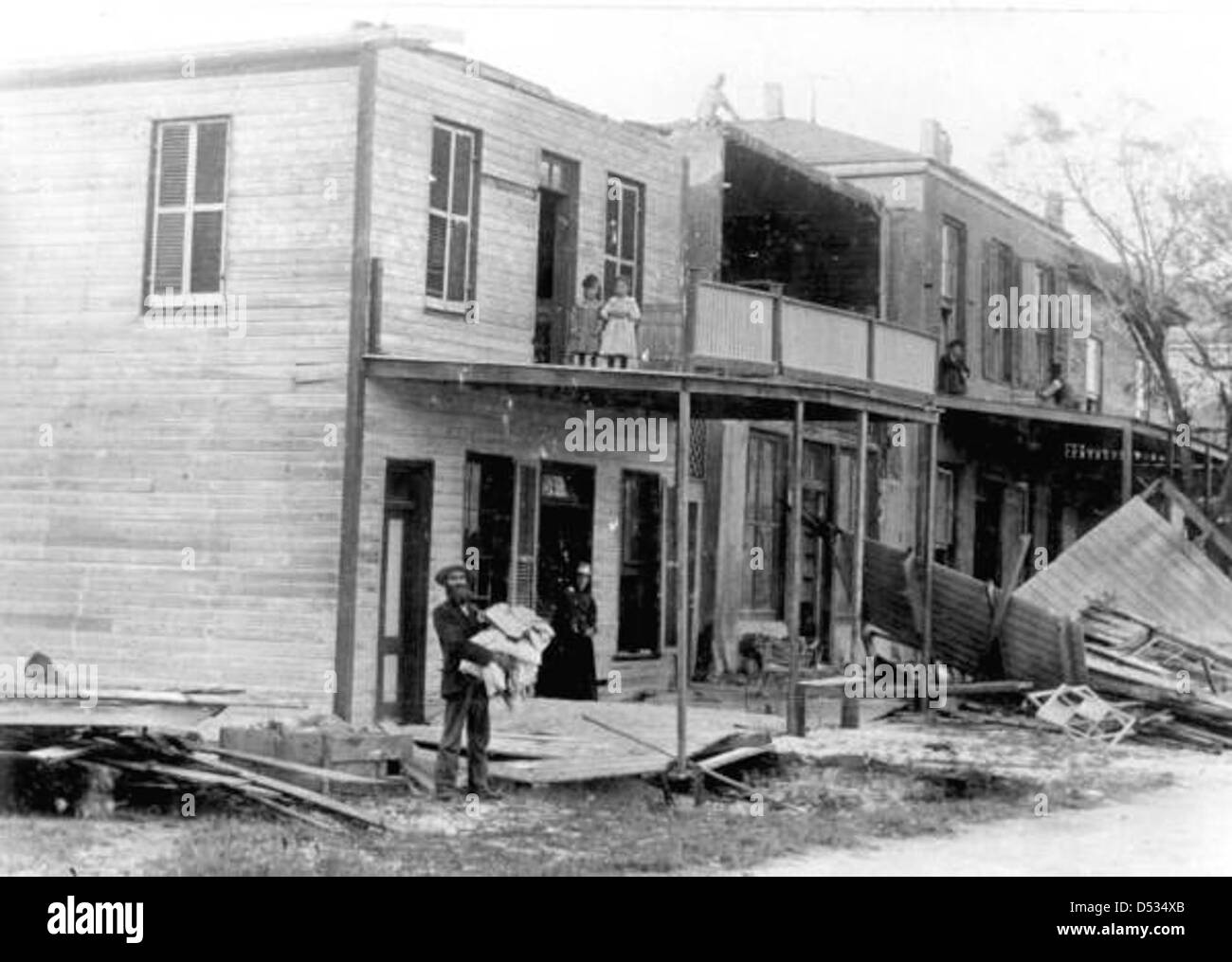 This image shows victims gathered near a building that was devastated by a hurricane in Cedar ...