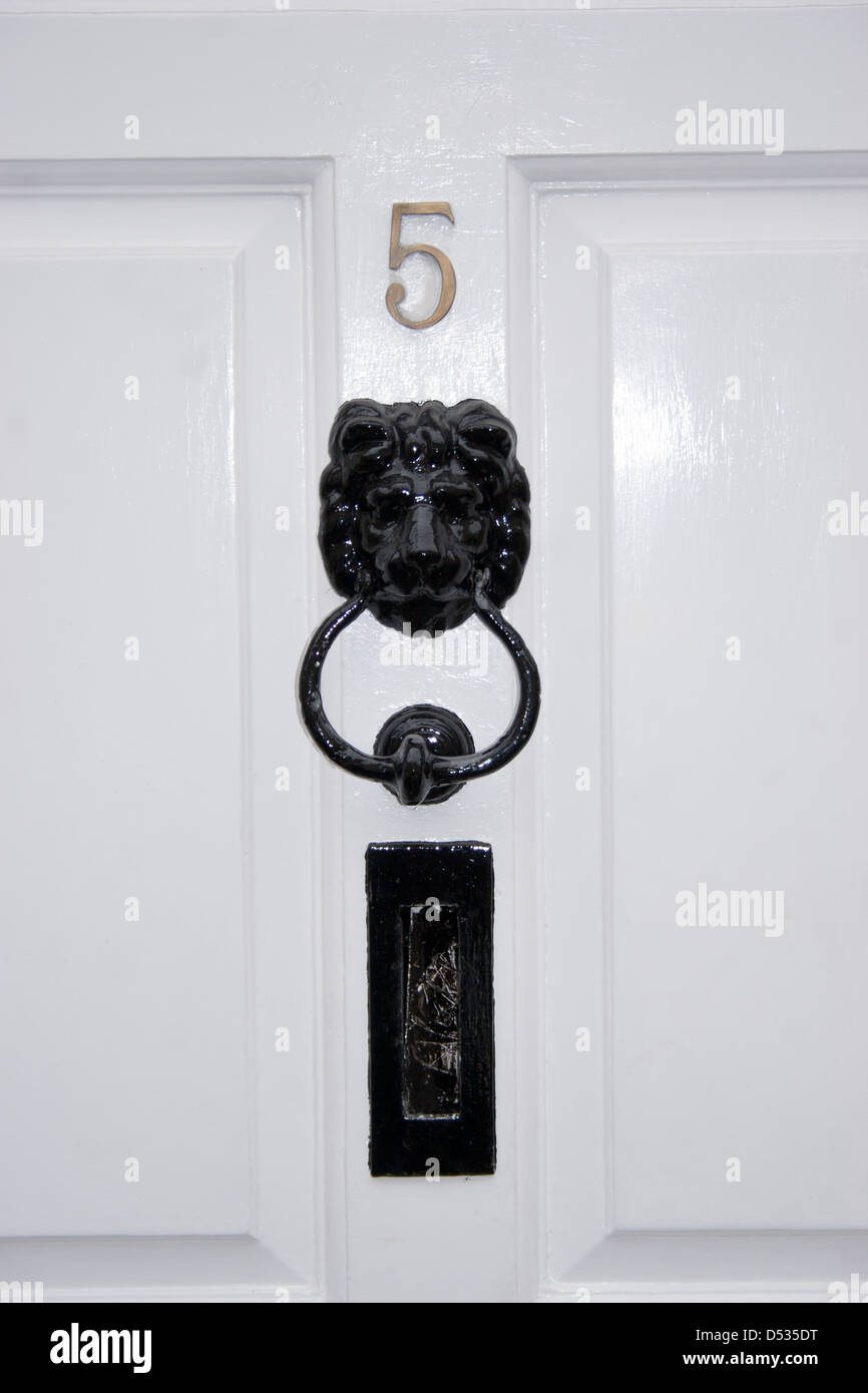 Front Door Detail Of Traditional English House With Black Lion