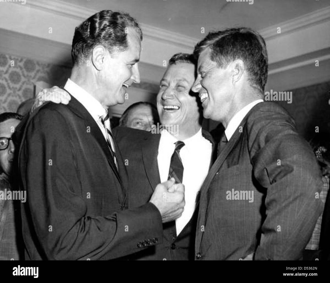 U.S. Senator George A. Smathers talking fun with Governor Collins and President Kennedy Stock Photo
