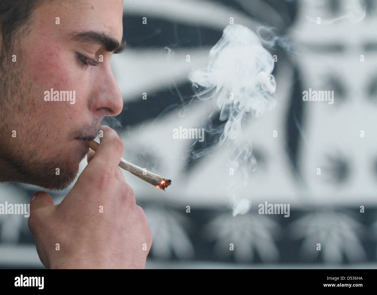 A young man smoking a cannabis joint Stock Photo
