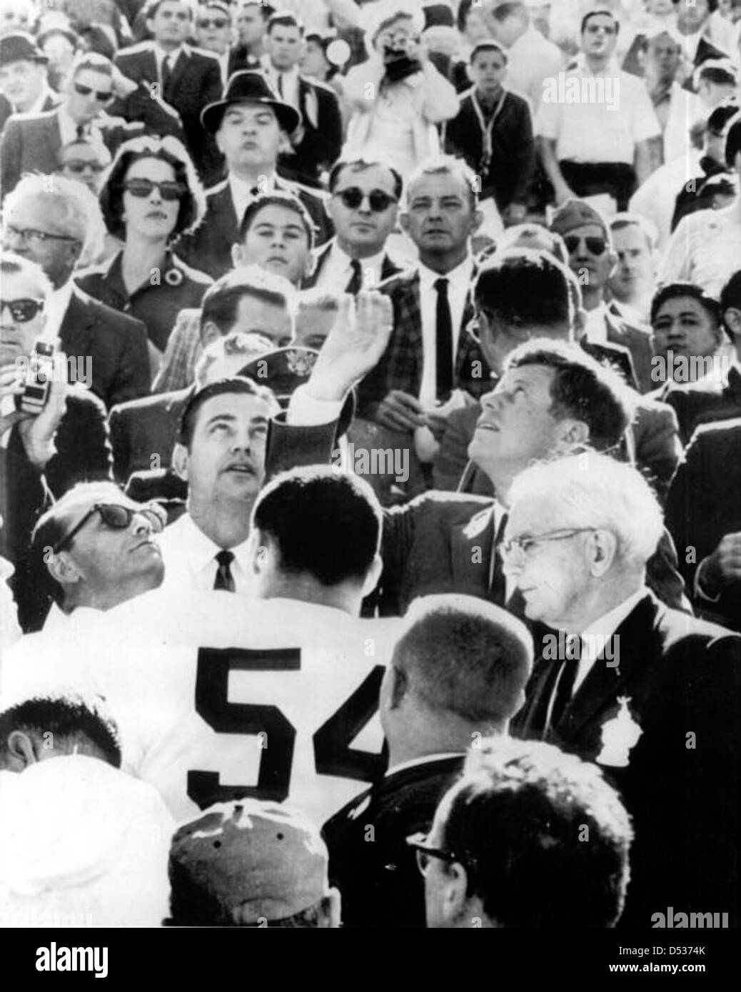President John F. Kennedy Tossing Coin to Start the Orange Bowl: Miami, Florida Stock Photo