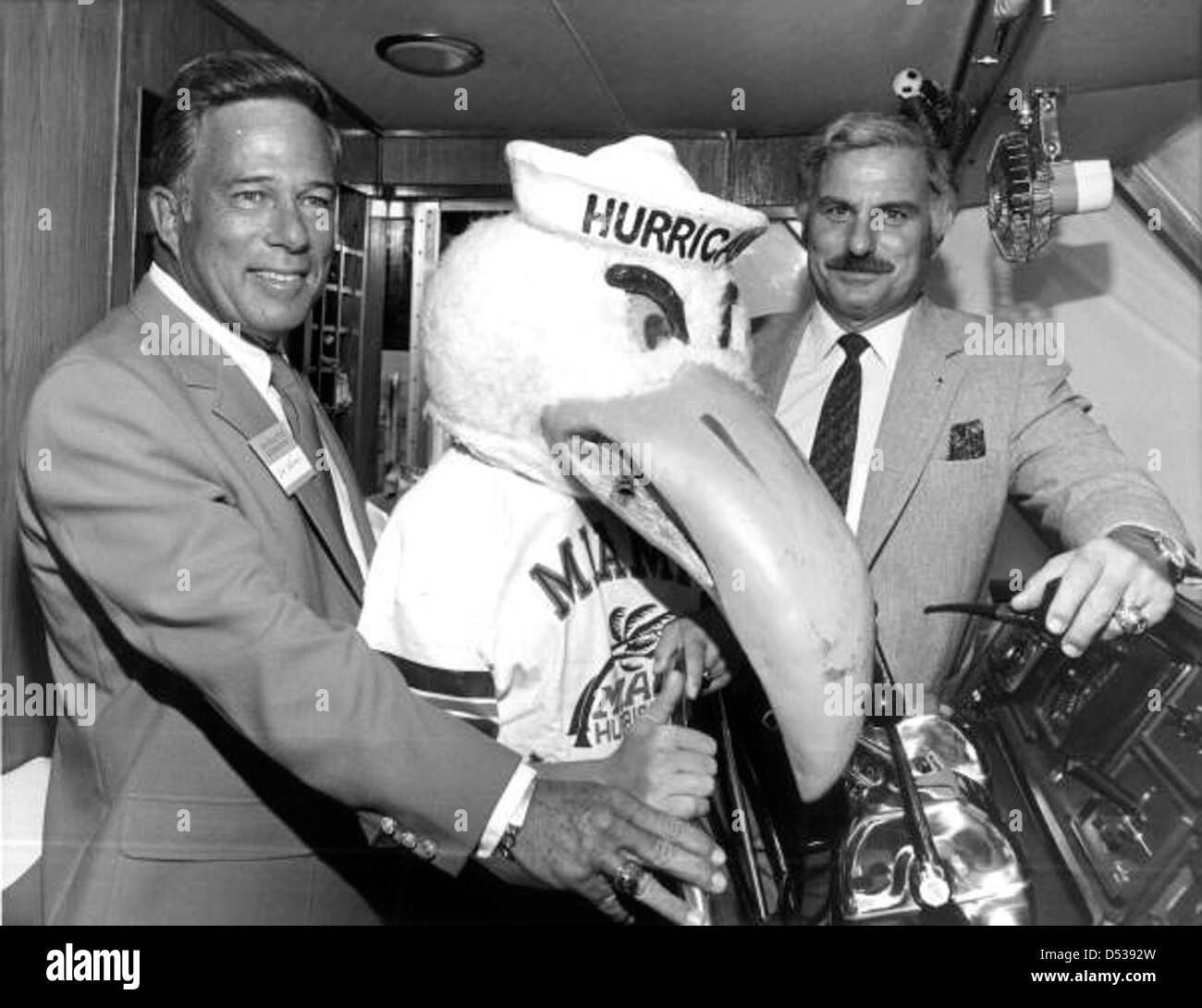 University of Miami head football coach Howard Schnellenberger, right, posing with Don Works and the school mascot for group portrait: Fort Lauderdale, Florida Stock Photo
