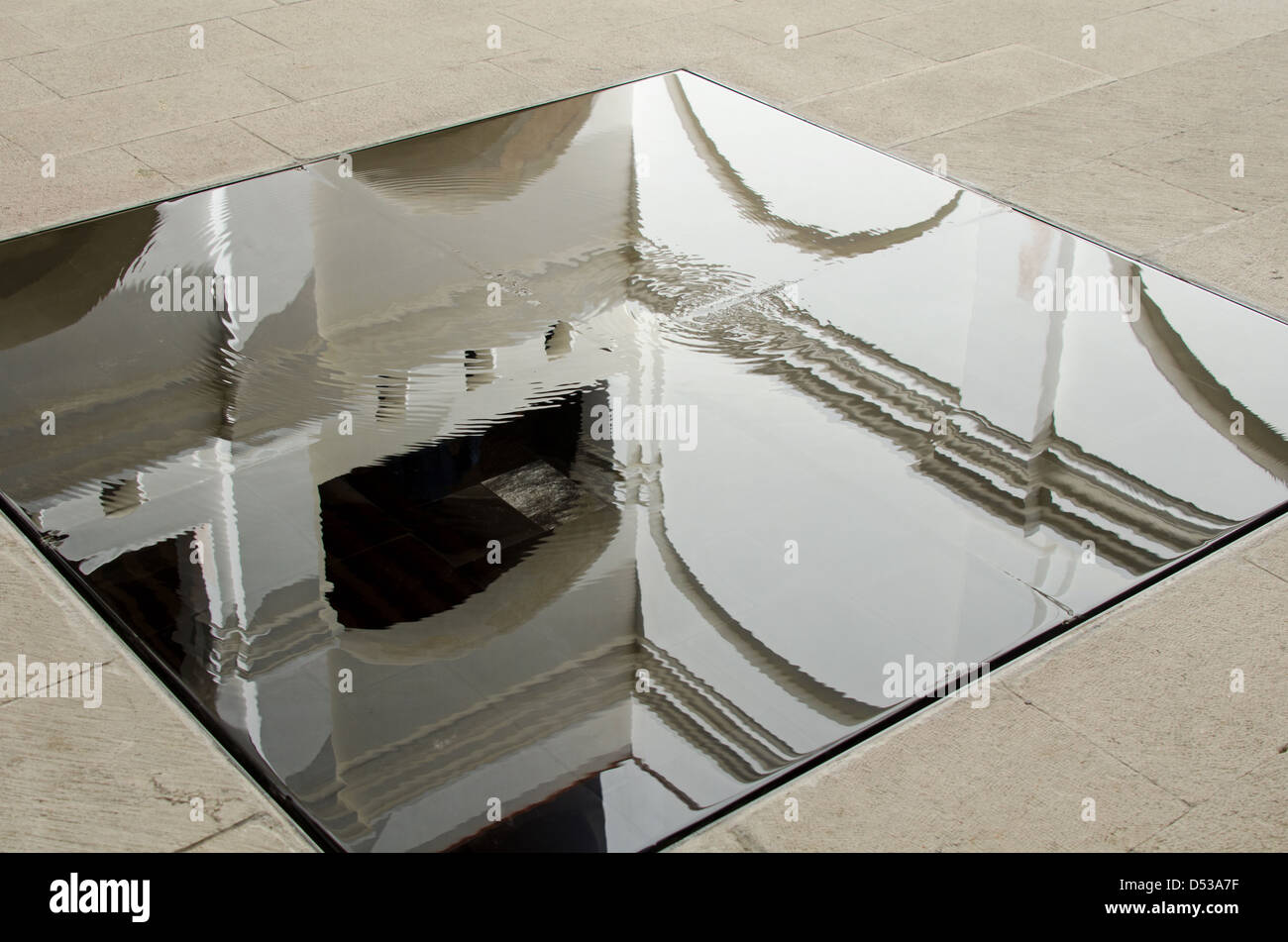 A shallow pool in the courtyard of the Centro Académico y Cultural San Pablo reflects the white arches of the old convent. Stock Photo