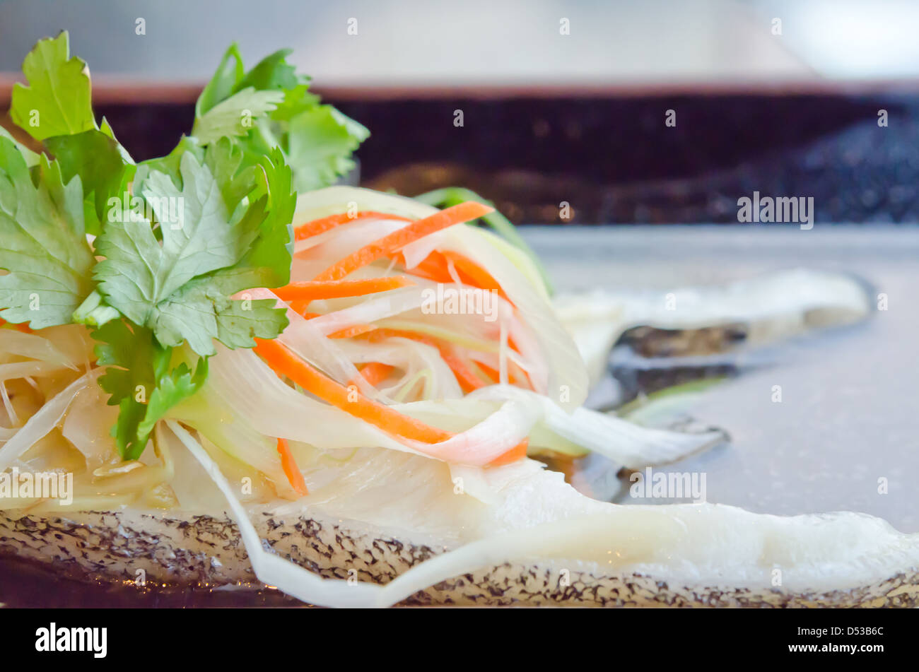 close up steamed white fish fillet with vegetable on plate Stock Photo