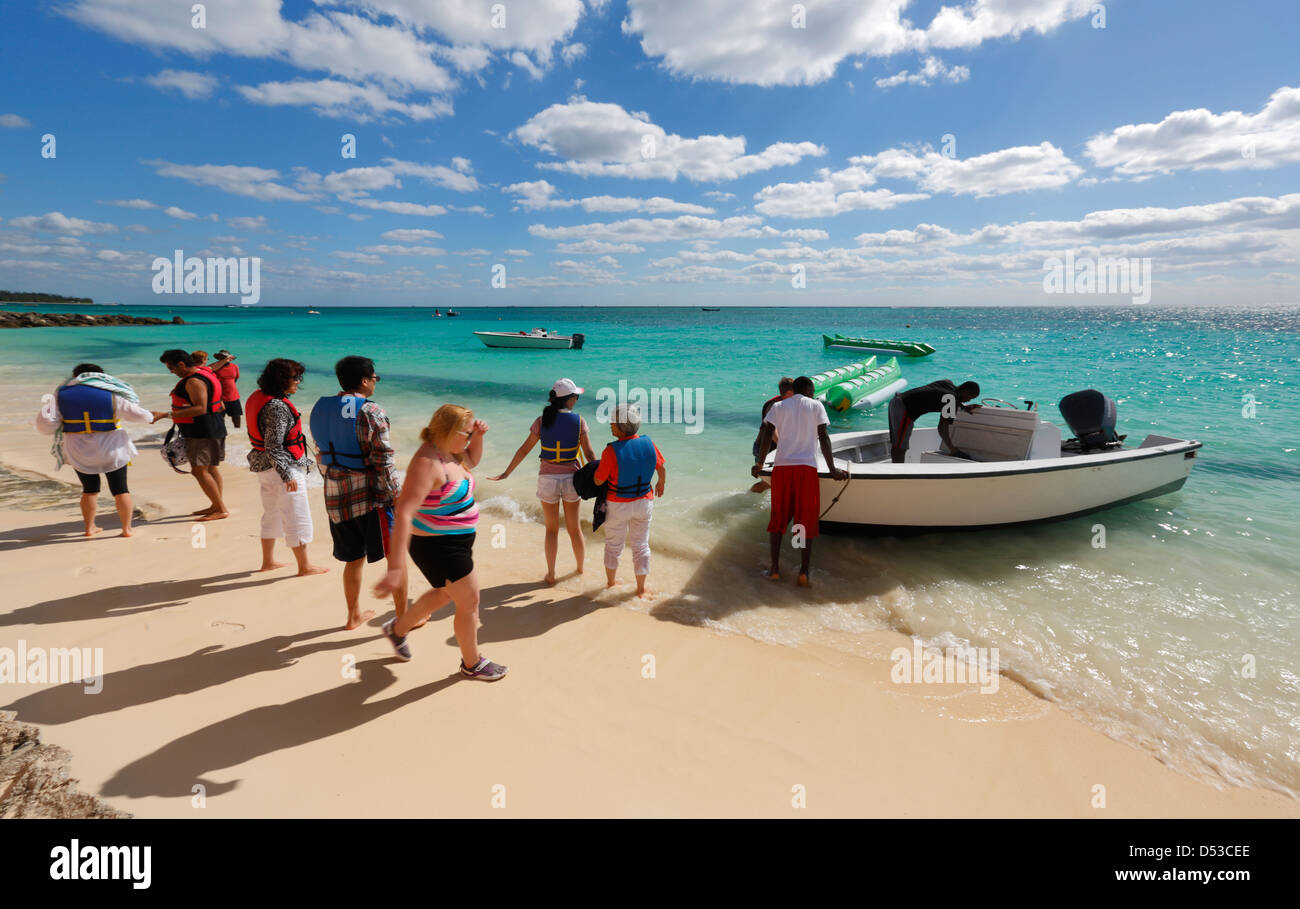 Group of tourists on the beach in Port Lucaya, Freeport, Bahamas Stock