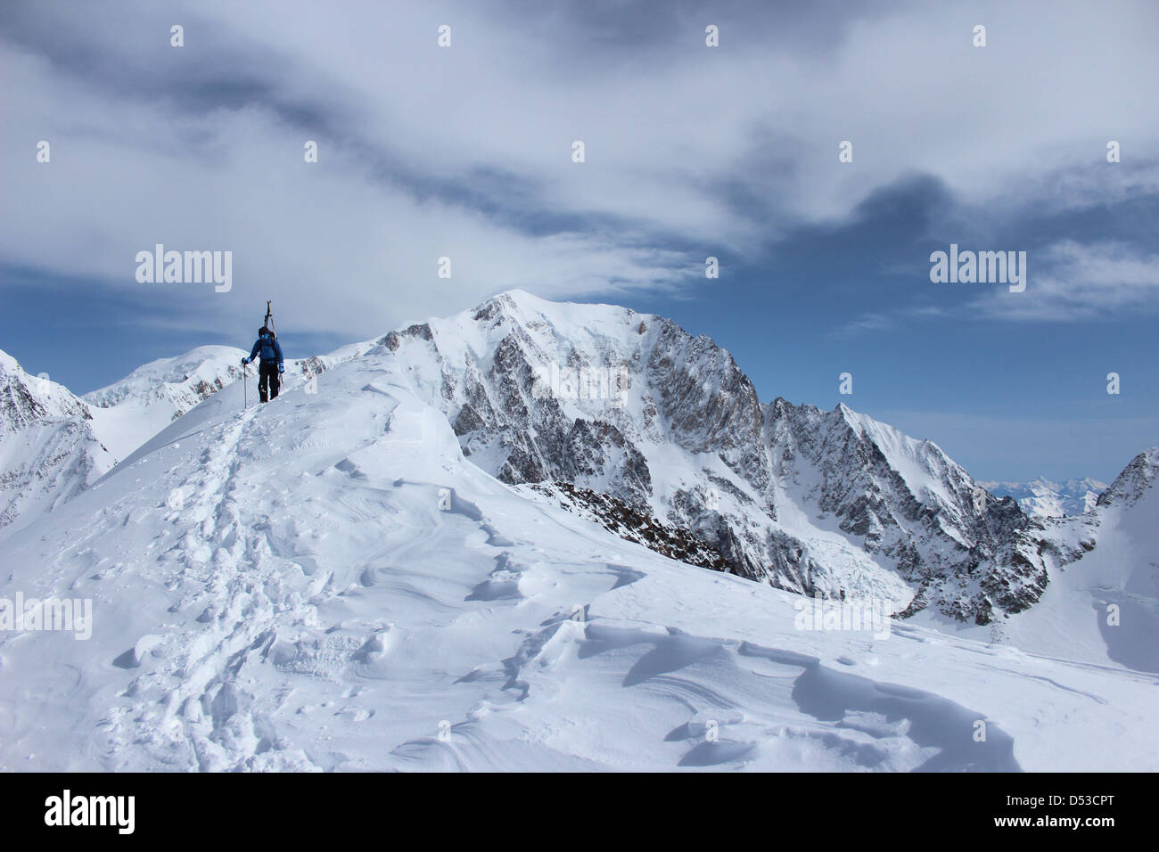 Ski tour ridge of Domes de Miage. Summit of Mont Blanc in background. Stock Photo