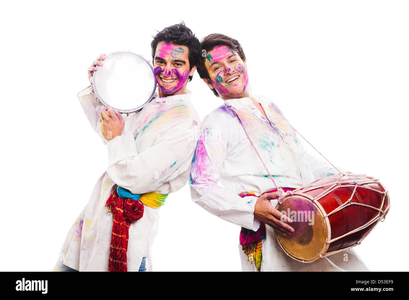 Friends celebrating Holi with musical instruments Stock Photo