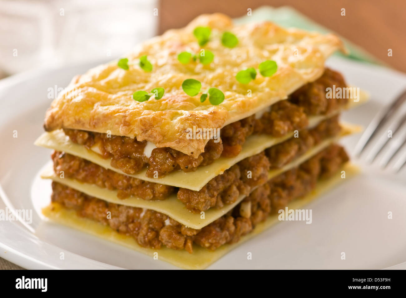 piece of lasagna on white plate Stock Photo
