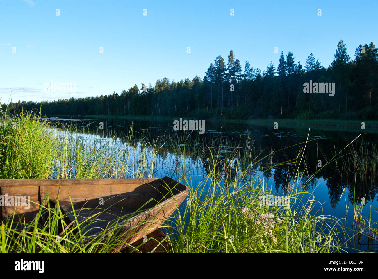 Lakeside scene with wooden boat, Finland. Stock Photo