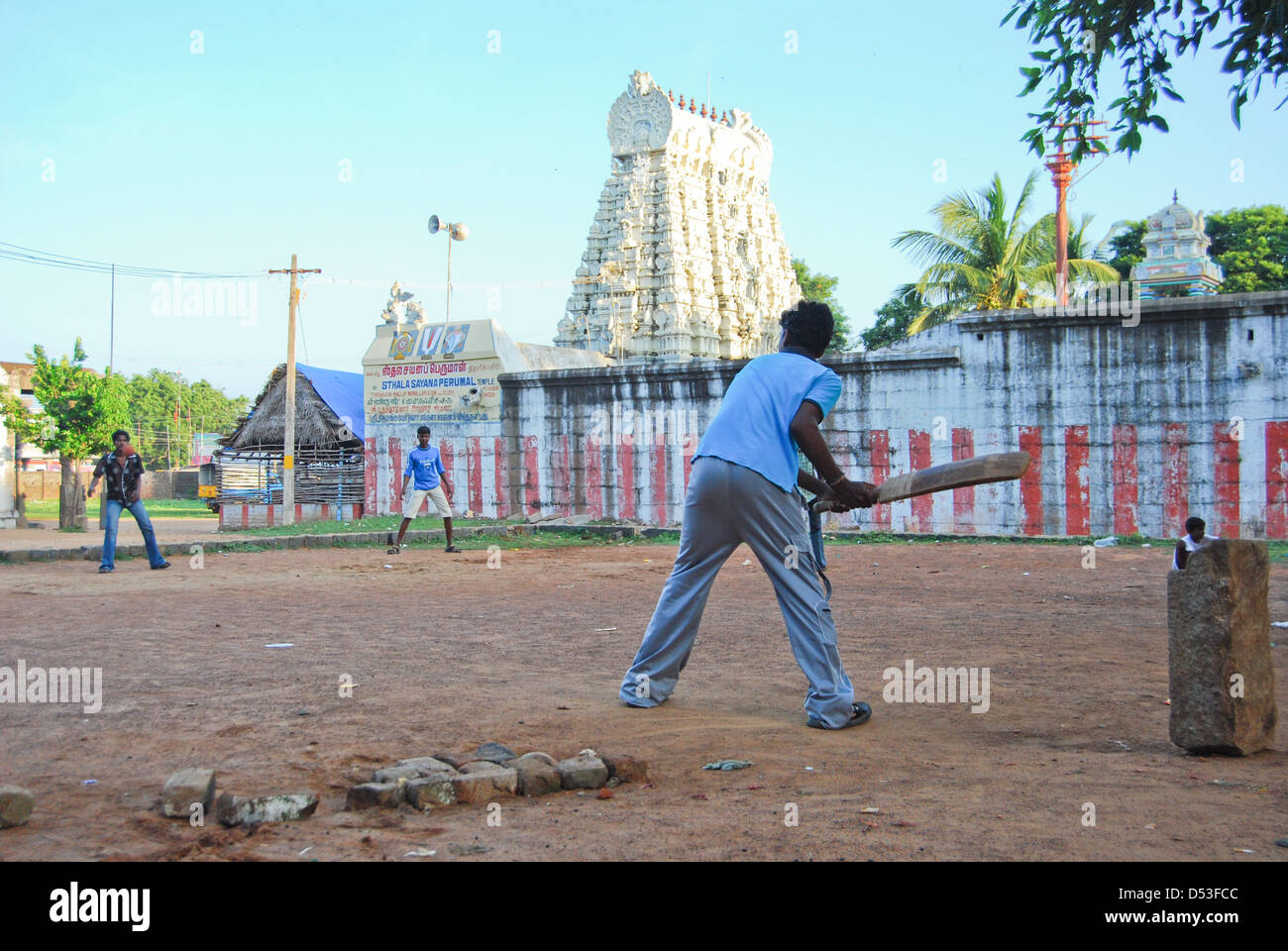 Children Playing Cricket in front of a temple, Mamallapuram, Tamil Nadu, India. Stock Photo