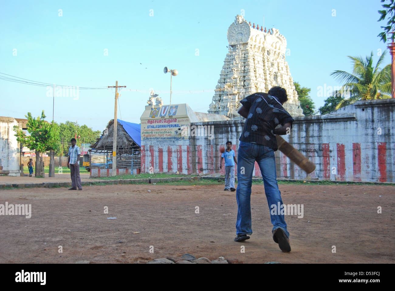 Children Playing Cricket in front of a temple, Mamallapuram, Tamil Nadu, India. Stock Photo
